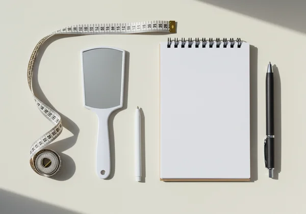 Tools for measuring face: tape, mirror, pen, paper.